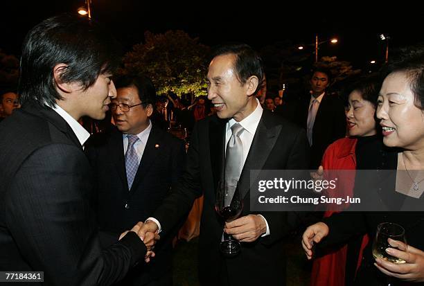 Lee Myung-Bak, center, the presidential candidate from the Grand National Party attends the opening ceremony party for the 12th Pusan International...