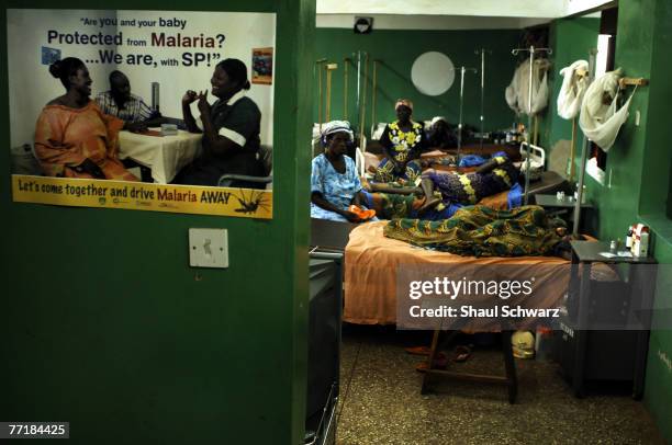 Poster advising of malaria protection is hanged outside the hospital where many infected children are treated September 18, 2007 in the Kintampo...