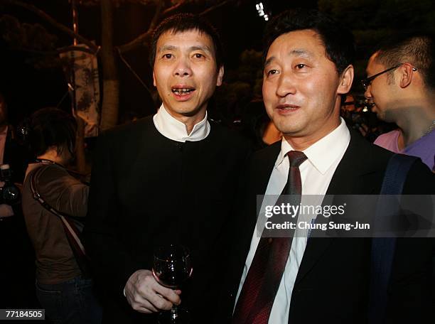 Director Feng Xiaogang, left, attends the opening ceremony party for the 12th Pusan International Film Festival October 4, 2007 in Pusan, South...