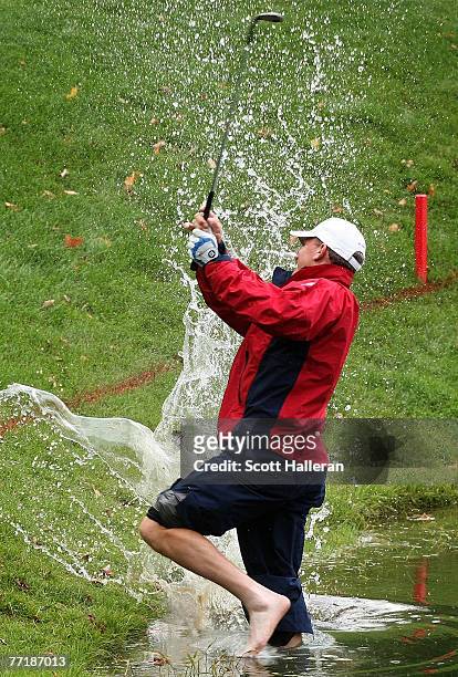 Woody Austin of the U.S. Team hits a shot from the water on the 14th hole during the round two fourball matches at the Presidents Cup at The Royal...