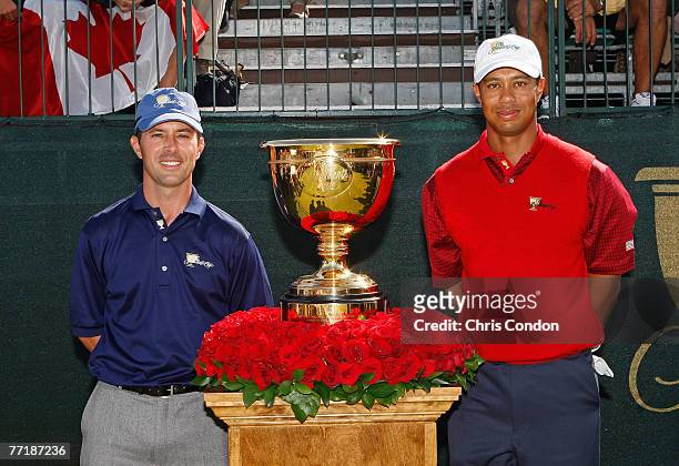 Mike Weir of the International team, and Tiger Woods of the U.S. Team pose with the Presidents Cup trophy on the first tee during the fifth round of...