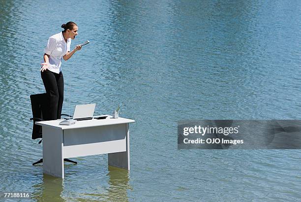 a woman on her office chair on top of water - negative photo illusion stock pictures, royalty-free photos & images