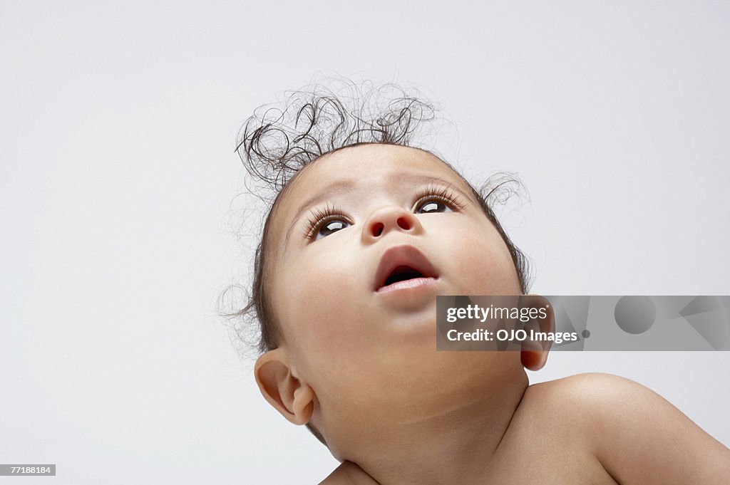 A baby boy looking up