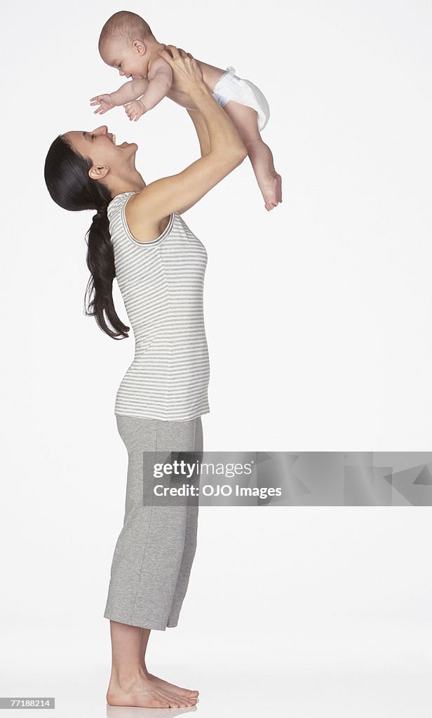 A woman playing with a baby