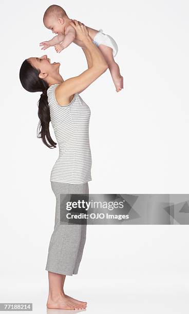 a woman playing with a baby - mother holding baby white background stock pictures, royalty-free photos & images