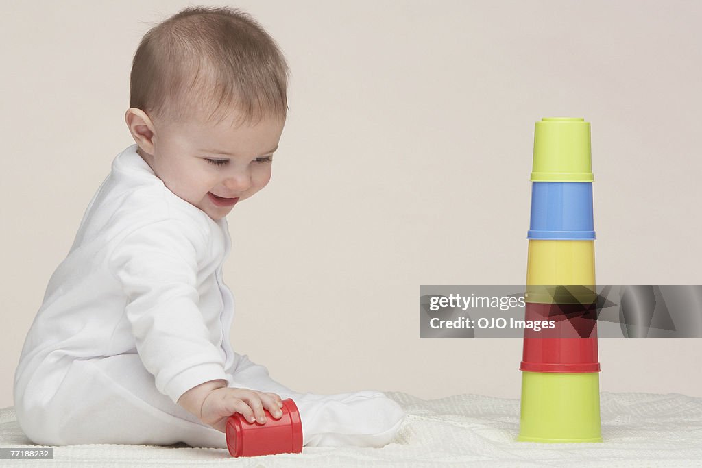 A baby playing with building toys