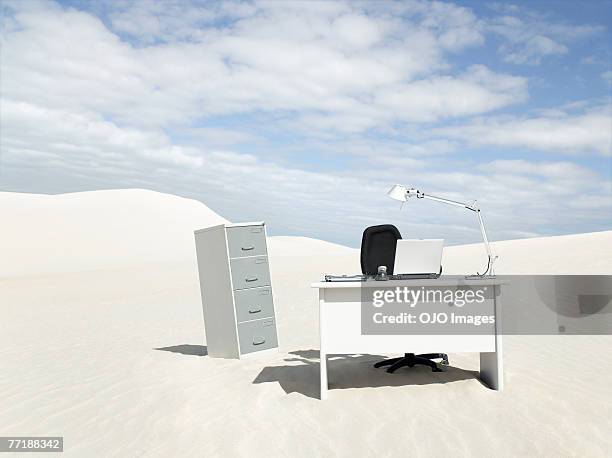 an empty desk in the middle of a desert - office solitude stock pictures, royalty-free photos & images