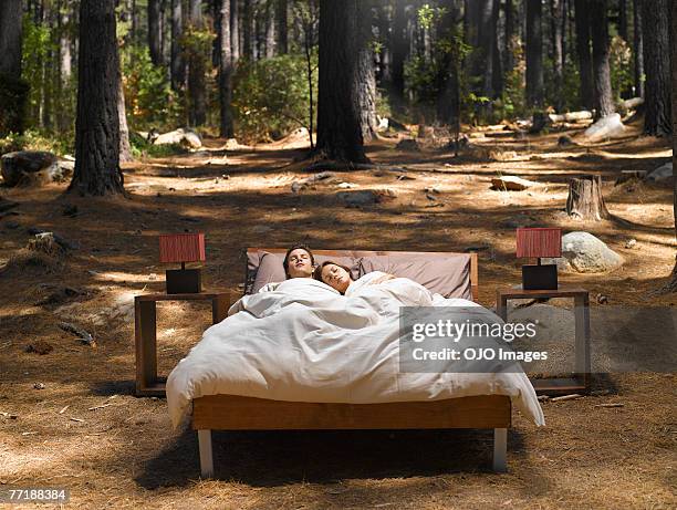 un couple, dormir dans un lit d'extérieur en bois - insolite photos et images de collection