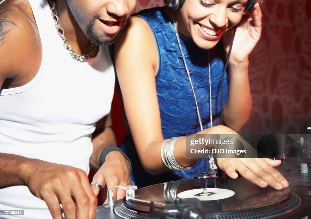 A DJ and a woman at a club
