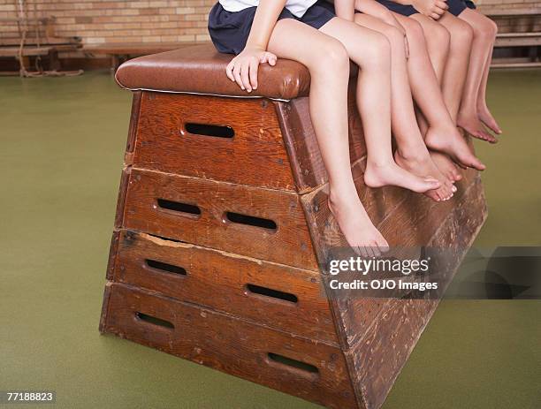 legs of students in gym class - gymnastiek stockfoto's en -beelden