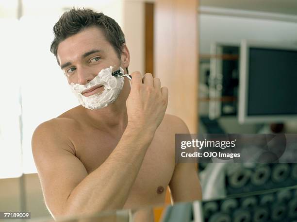 a man shaving - shaving cream stockfoto's en -beelden