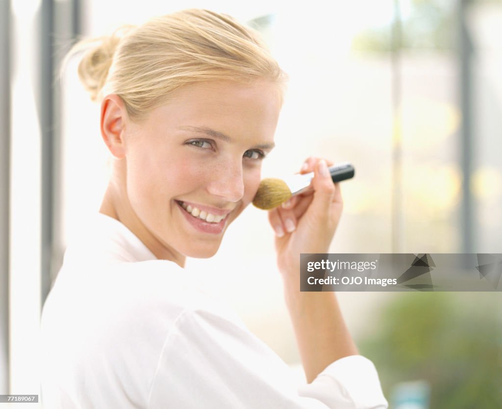A woman applying make-up