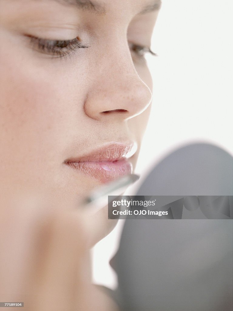 A woman applying make-up