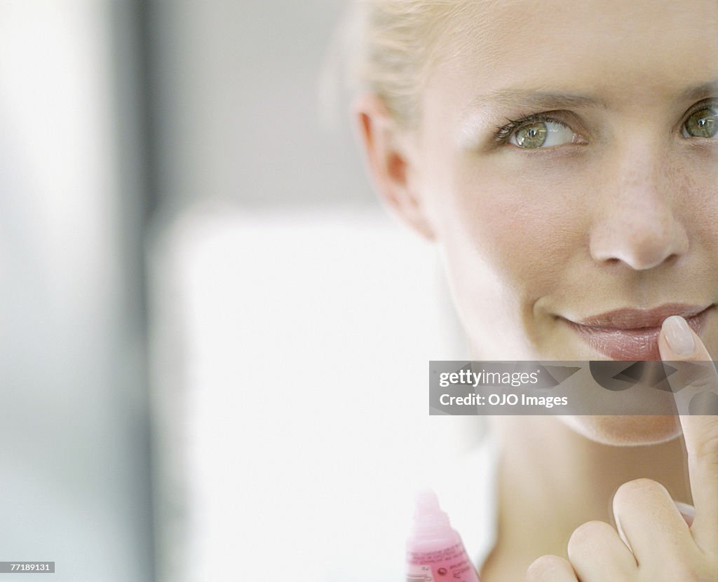 A woman applying make-up