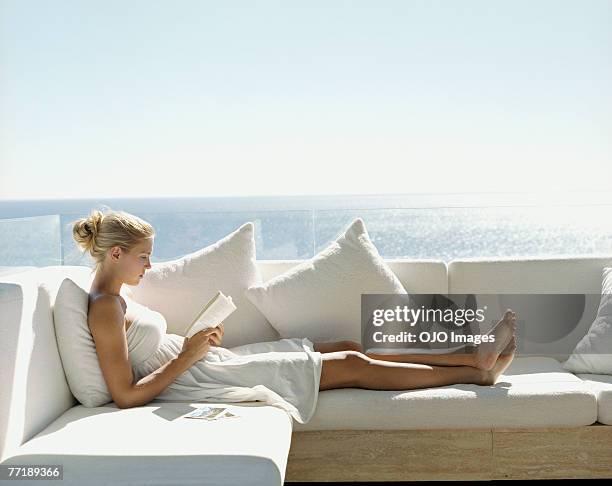 a woman reading a book - women with nice legs stock pictures, royalty-free photos & images