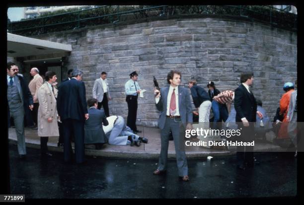 Chaos surrounds shooting victims immediately after the assassination attempt on President Reagan, March 30 by John Hinkley Jr. Outside the Hilton...