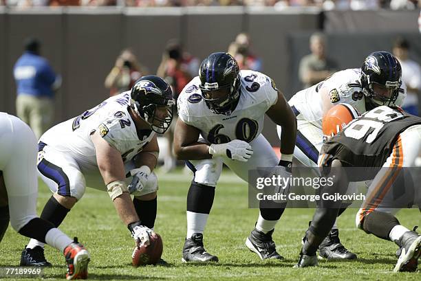 Center Mike Flynn and offensive guard Jason Brown of the Baltimore Ravens confer before the start of a play during a game against the Cleveland...