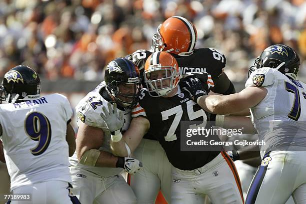 Center Mike Flynn and offensive lineman Marshal Yanda of the Baltimore Ravens doubleteam defensive lineman Simon Fraser of the Cleveland Browns at...