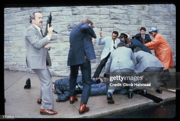 Chaos surrounds shooting victims immediately after the assassination attempt on President Reagan, March 30 by John Hinkley Jr. Outside the Hilton...