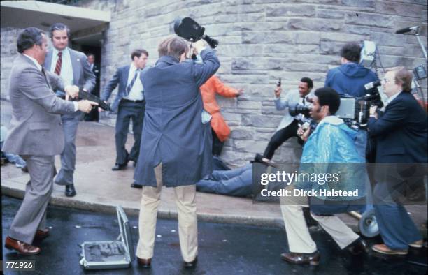 Chaos surrounds shooting victims immediately after the assassination attempt on President Reagan, March 30 by John Hinkley Jr. Outside the Hilton...