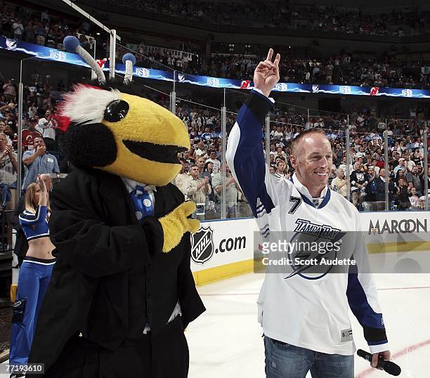 Jeff Garcia of the Tampa Bay Buccaneers announces "Let's Play Hockey" with team mascot Thunder Bug at the start of Tampa Bay Lightning home opener...