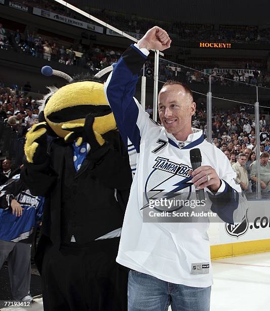 Jeff Garcia of the Tampa Bay Buccaneers announces "Let's Play Hockey" with team mascot Thunder Bug at the start of Tampa Bay Lightning home opener...