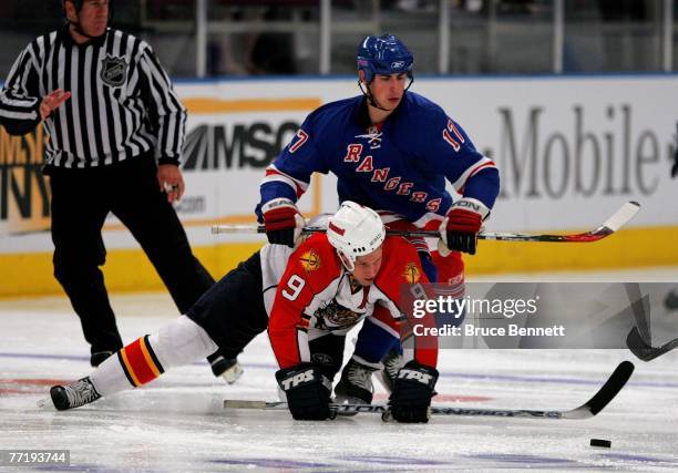 Stephen Weiss of the Florida Panthers gets hit with the stick by Brandon Dubinsky of the New York Rangers on October 4, 2007 at Madison Square Garden...