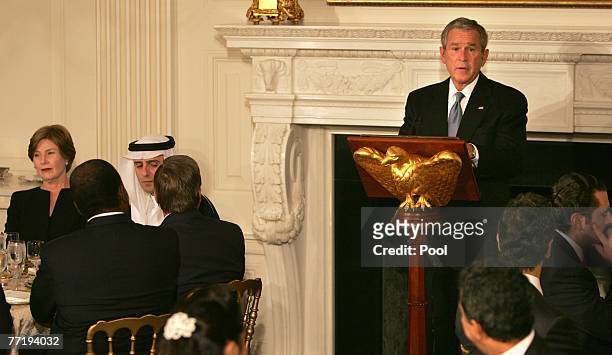 President George W. Bush speaks at the Iftaar Dinner as first lady Laura Bush and Adel al-Jubeir , Saudi Arabian ambassador to the U.S., look on in...