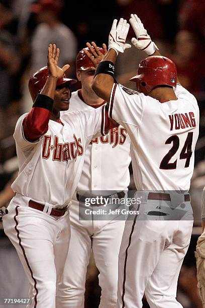 Chris Young of the Arizona Diamondbacks gives teammate Justin Upton a high-five along with Chris Snyder after hitting a three-run homerun in the...