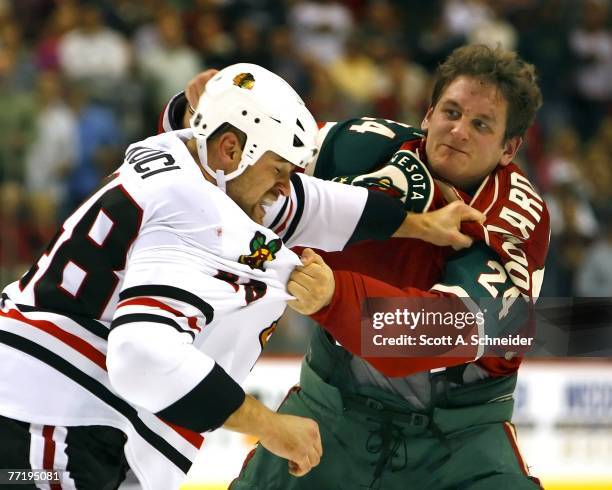 David Koci of the Chicago Blackhawks and Derek Boogaard of the Minnesota Wild fight in the second period of their game October 4, 2007 at the Xcel...