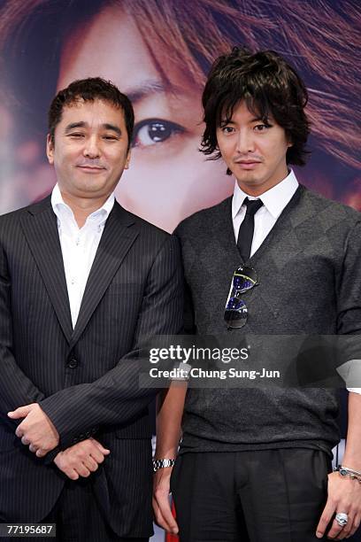 Director Masayuki Suzuki and actor Takuya Kimura attend a photocall after their press conference at the premiere of 'HERO' at the 12th Pusan...