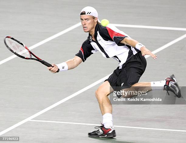 Lleyton Hewitt of Australia hits a return shot against Ivo Karlovic of Croatia during Day 5 of the AIG Japan Open Tennis Championships held at Ariake...