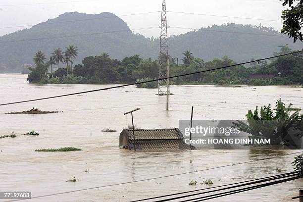 Flooded house is seen on the banks of the Ma river in the central province of Thanh Hoa, 05 October 2007, after Typhoon Lekima hit the central part...