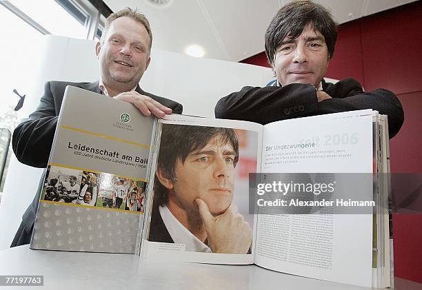 The head coach of the German National Football Team Joachim Loew poses together with publisher Stefan Postler with the new book "Leidenschaft am...