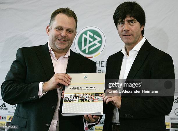 The head coach of the German National Football Team Joachim Loew poses together with publisher Stefan Postler with the new book "Leidenschaft am...