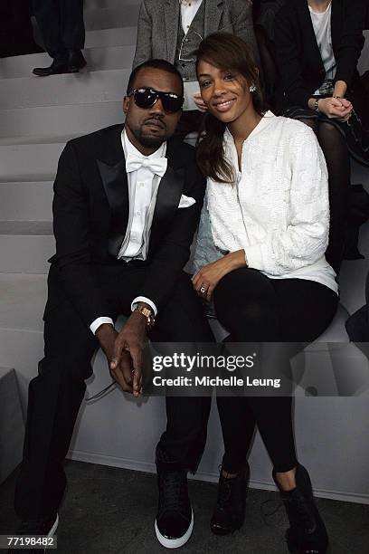 Kanye West and Alexis Phifer attend the Yves Saint Laurent PFW Spring Summer 2008 show at Paris Fashion Week 2007 on October 4, 2007 in Paris, France.