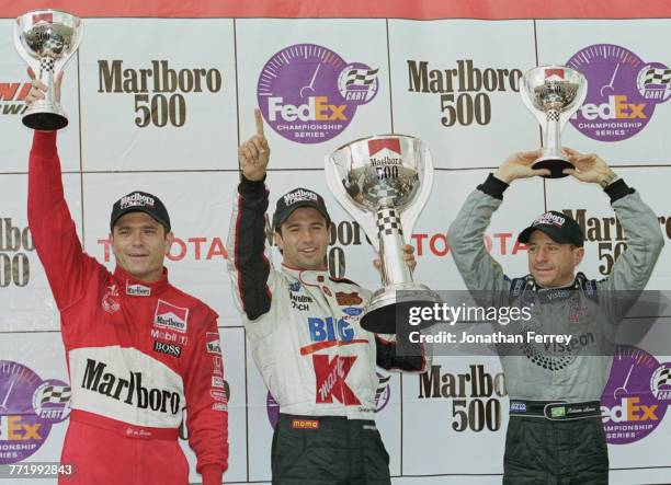 Christian Fittipaldi of Brazil and driver of the Newman/Haas Racing Lola B2K/00 Ford-Cosworth XF celebrates with compatriots second placed Roberto...