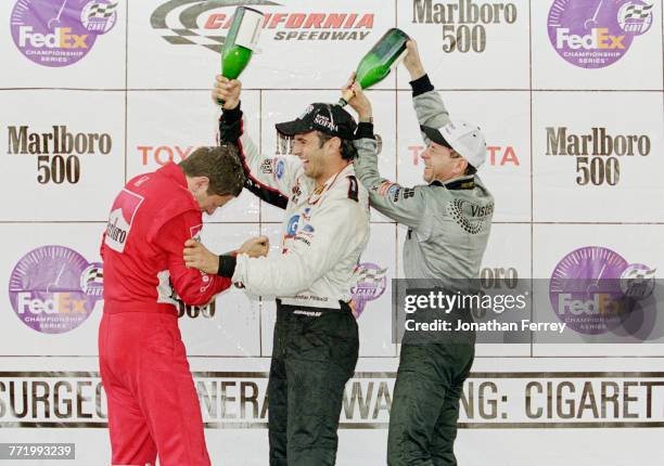 Christian Fittipaldi of Brazil and driver of the Newman/Haas Racing Lola B2K/00 Ford-Cosworth XF celebrates with compatriots second placed Roberto...