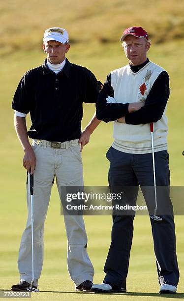 Marcel Siem and Boris Becker, both of Germany, chat together on the second green during the second round of The Alfred Dunhill Links Championship at...