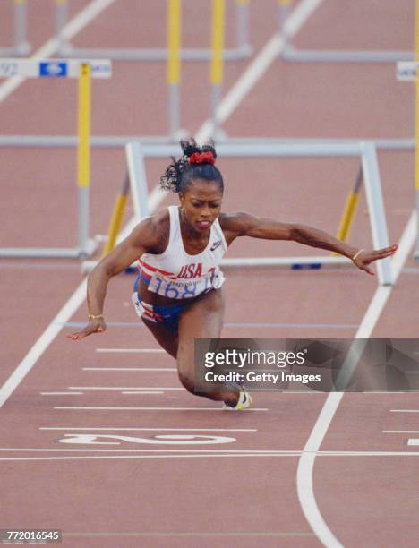 Gail Devers of the United States stumbles and falls across the finishing line after clipping the10th hurdle in the Women's 100 metres Hurdles final...