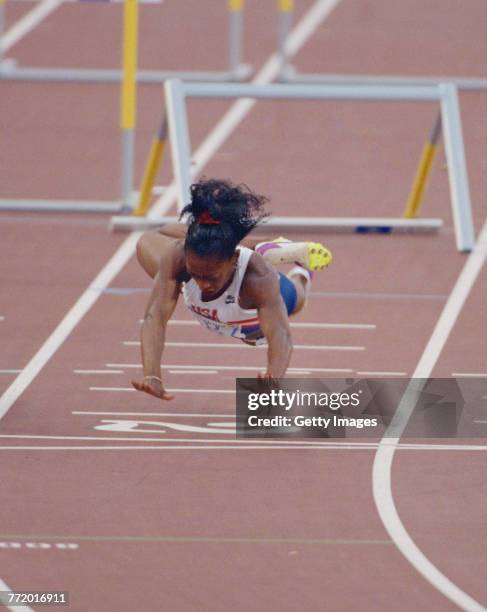 Gail Devers of the United States stumbles and falls across the finishing line after clipping the10th hurdle in the Women's 100 metres Hurdles final...