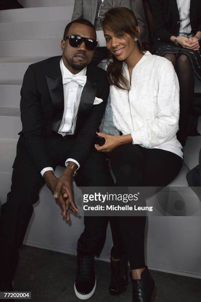 Kanye West and Alexis Phifer attend the Yves Saint Laurent PFW Spring Summer 2008 show at Paris Fashion Week 2007 on October 4, 2007 in Paris, France.