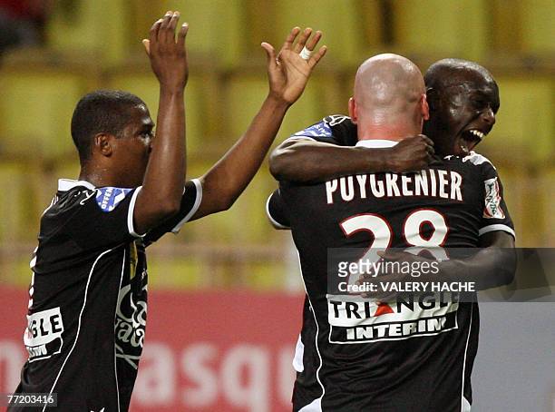 Nancy's defender Sebastien Puygrenier , forwards Kim and Marc-Antoine Fortune jubilate after their team scored a goal during their French L1 football...