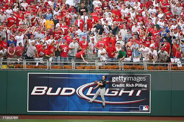 Matt Holliday of the Colorado Rockies leaps for a home run ball during the game one of the National League Division Series against the Philadelphia...
