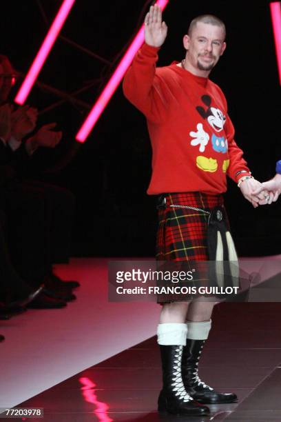 British designer Alexander Mcqueen waves at the end of his Spring/Summer 2008 ready-to-wear collection show in Paris, 05 October 2007. AFP PHOTO...