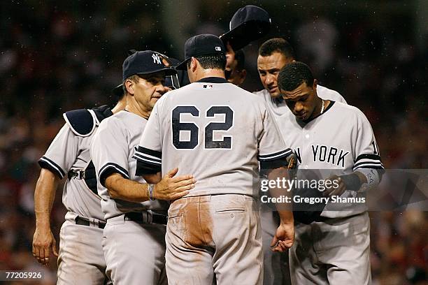 Gnats swarn the mound as manager Joe Torre of the New York Yankees talks with relief pitcher Joba Chamberlain as his teammates try to swat the...