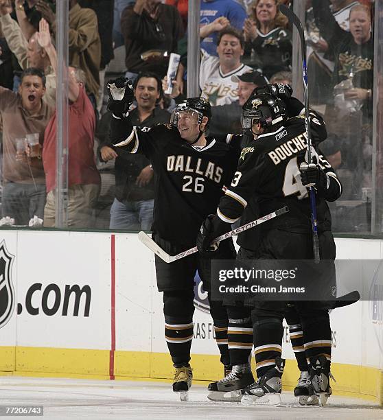 Jere Lehtinen, Philippe Boucher and Niklas Hagman of the Dallas Stars celebrate a second period goal by Hagman against the Boston Bruins at the...