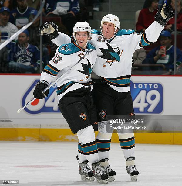 Torrey Mitchell of the San Jose Sharks celebrates his first NHL assist with teammate Jeremy Roenik after Roenik scored his second goal against the...