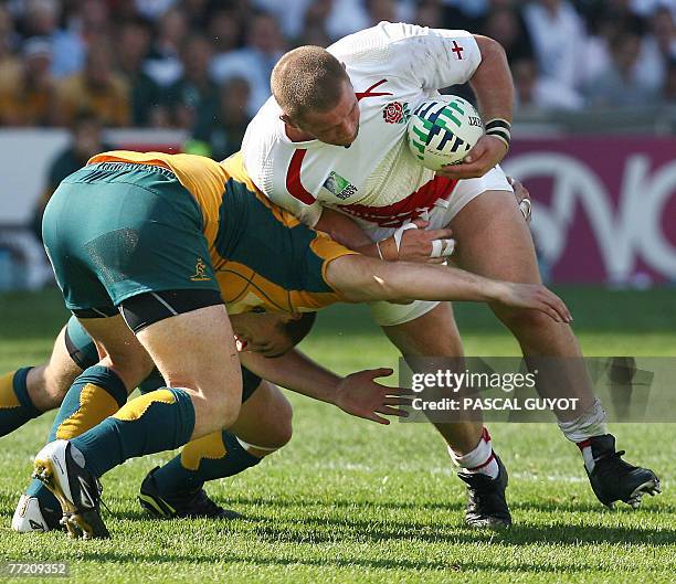 England's prop and captain Phil Vickery is tackled by Australia's fullback Chris Latham during the rugby union World Cup quarter final match...