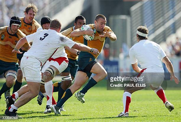 Australia's fullback Chris Latham tries to escape from England's defence during their rugby union World Cup quarter final match Australia vs....